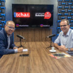 O jornalista Eduardo Tchao e o ex-prefeito do Rio de Janeiro e pré-candidato ao Governo do Estado pelo PSD, Eduardo Paes, posam durante a gravação do sexto episódio do Boletim Cast. Os dois estão sentados à mesa do estúdio, com microfones à frente, enquanto um monitor ao fundo exibe as logomarcas do Canal do Tchao e do Boletim Cast.