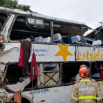Bombeiro observa ônibus da Estrela Guia destruído após acidente na BR-040, em Petrópolis.